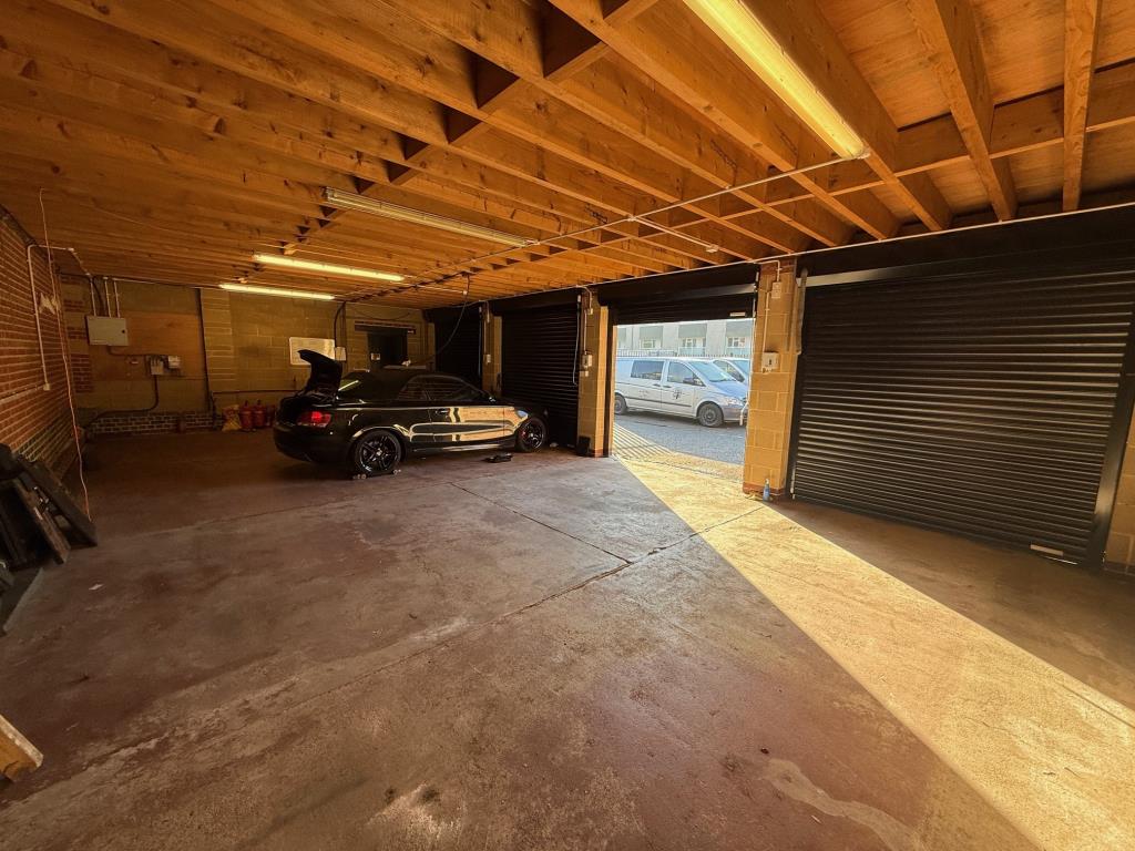 Lot: 78 - GARAGES AND FORECOURT WITH POTENTIAL - Alternative view of garages inside showing the depth and height